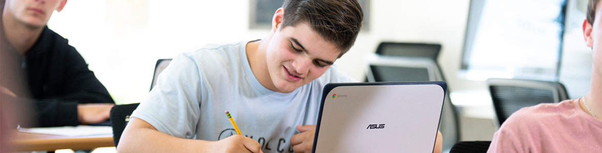Teen boy writing in the Learning Center