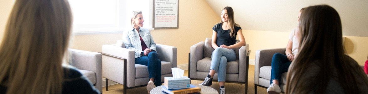 A group of women sitting in chairs in a room.