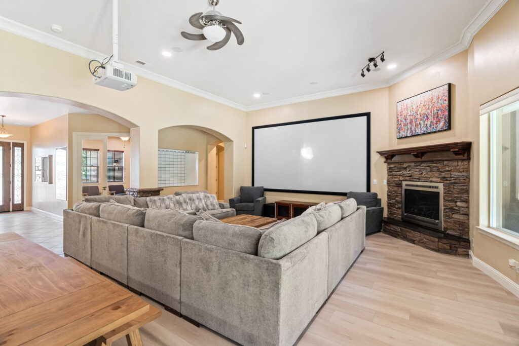 A living room with a fireplace and a flat screen tv.