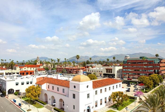 An aerial view of riverside in california with mountains in the background.