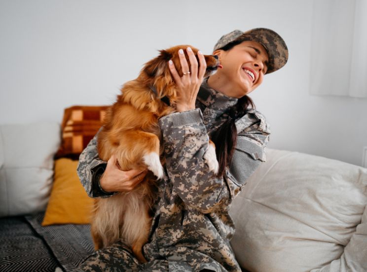 Veteran reconnecting with emotional support dog during therapy at Muir Wood