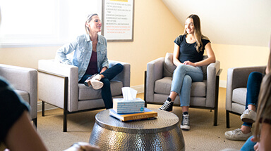 Adolescents collaborating during therapeutic learning activity at Muir Wood